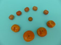 WITHDRAWN Four large amber beads and six similar beads,