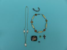 An ivory and agate necklace, coral and pearl necklace, painted brooch,