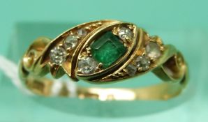 An 18ct gold ring set with a square cut emerald surrounded by diamonds (size N), weight 2.
