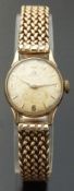 Omega ladies 9ct gold wristwatch, with gold hands and markers and marbled face,