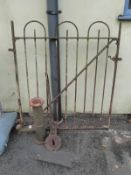 A cast iron pump and a metal gate