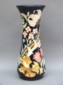 A Moorcroft vase decorated with flowers dated 93, monogram to base,
