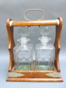 An oak two bottle tantalus,