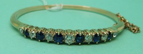 A Victorian bangle set with alternating diamonds and sapphires,