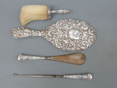 A hallmarked silver mounted hand mirror, crumb brush,