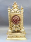 A highly ornate French mantel clock in gilt brass pierced case supported on spiralled floral and