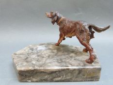 A bronze cold painted setter on marble dish
