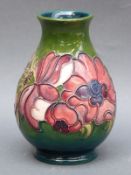 A Moorcroft vase in Anemone pattern on a green ground, 13.