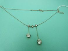A Victorian platinum necklace set with three old English cut diamonds and two further drop diamonds