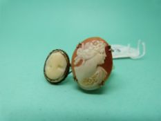 A yellow metal ring set with an oval cameo depicting a lady and another yellow metal cameo ring