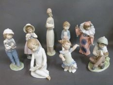 A collection of Nao child figures including boy with cake,