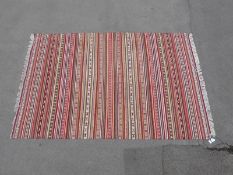 A striped kilim rug (300 x 202cm)