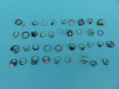 A collection of 39 silver/white metal dress rings including pearl, ruby,