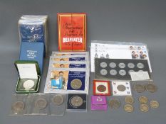 A collection of commemorative coins in packets 'Britains First Decimals', cased crowns,