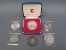 Six silver coins including Victorian crown, double florin, liberty dollar, Maria Theresia,