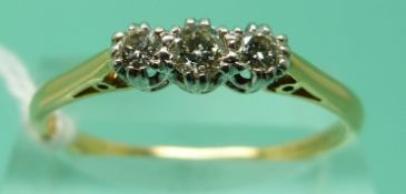 An 18ct gold ring set with three diamonds in a platinum setting (size V), weight 2.