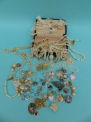 A collection of costume jewellery to include faux pearls, silver brooch, 9ct gold earrings,