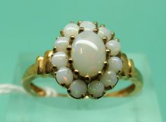 A 9ct gold ring set with opals in a cluster (size P)