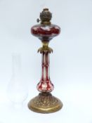 A gilt metal and flash overlaid glass lamp,