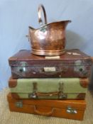 Three vintage suitcases including a leather example and copper coal scuttle