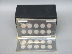 An amateur collection of English shillings mounted in cards, ranging from 1951-1958,