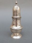 An Edward VII hallmarked silver pepper, London 1907, maker D & J Welby Ltd, height 11.