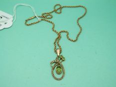An Edwardian 9ct gold pendant set with peridot and seed pearls on a 9ct gold rope twist chain,