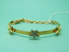 An 18ct gold bracelet set with diamonds in a star setting and two other gold stars,