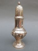 An Edward VII hallmarked silver sugar caster with wrythen lower body,