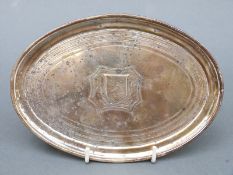 A George III hallmarked silver card tray or teapot stand of oval form,