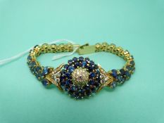 An 18ct gold bracelet the central circular panel set with diamonds totalling approximately 1.