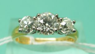 A 22ct gold ring set with an old English cut diamond measuring approximately 1ct flanked by two old