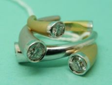 An 18ct gold ring set with five round brilliant cut diamonds measuring approximately 0.45, 0.4, 0.