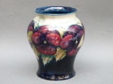 A Moorcroft vase in the Pansy pattern on blue ground,