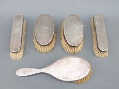 Five hallmarked silver-mounted dressing table brushes