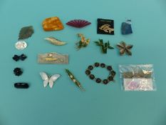 A collection of jadeite and mother-of-pearl brooches,