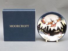 A Moorcroft pin tray decorated with Santa, reindeers and sleigh flying over the Potteries,