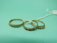 A 9ct gold ring set with three diamonds,