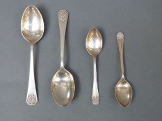 A pair of Arts & Crafts or Art Nouveau style silver teaspoons,