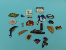A collection of largely treen and ceramic brooches to include dolphin, sheep, fish,