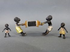 Austrian cold painted miniature bronze figures of two black children pulling on an accordion,