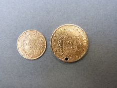 A Napoleon III 1865 20 franc gold coin (holed) together with an 1857 5 franc gold coin,