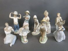 Nao figures including father and baby, boy with wide brimmed hat,