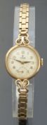 Tudor ladies 9ct gold wristwatch with inset subsidiary seconds dial, gold hands and Arabic numerals,