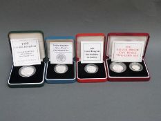 Four various cased Royal Mint silver proof UK coins to include Peace £2, 5 pence two coin set,