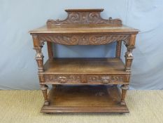 An oak carved three tier buffet (W108 x D48 x H124cm)