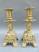 A pair of 19thC pierced gilt candlesticks,