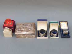 An Eastern white metal cigarette box with dragon decoration, marked silver to edge, width 13cm,