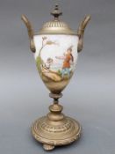 A 19thC brass mounted lidded continental porcelain goblet decorated with a romantic scene beside a
