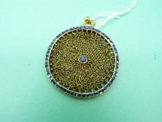 An 18ct gold coin purse set with a round cut sapphire to the centre,